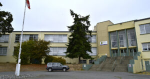 The front of the SJ Willis School building, with a roundabout and Canadian flag.